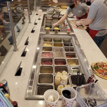 Your Pie - a group of people preparing food - Pizza Near Me - Milton, Georgia