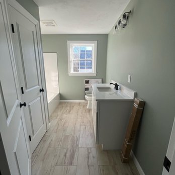 Rasi Remodeling & Renovations - a view of a bathroom with a sink and a window - General Contractors Near Me Rasi Remodeling & Renovations - a view of a bathroom with a sink and a window - General Contractors Near Me