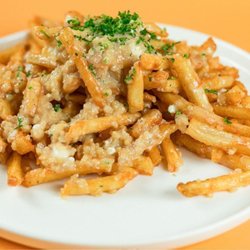 Santorini's - Greek Garlic Fries at Santorini's Riverton: A generous portion of garlic and feta piled high. Served with Santorini's House Dressing.