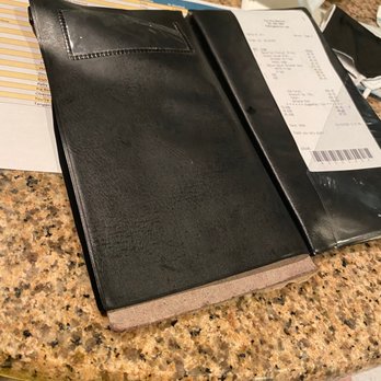The Mansion - The lowlight....how about splurging for a check holder that is not falling apart....this is the last thing the customer sees.... - New American Near Me - Melbourne, Florida