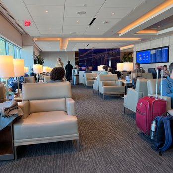 United Club - a woman sitting in a lounge area - Airport Lounges Near Me - Houston, Texas United Club - a woman sitting in a lounge area - Airport Lounges Near Me - Houston, Texas