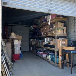 English Station Mini Storage - This is the large storage unit we used with overhead doors on either side of the unit with shelving, a ladder and overhead lighting.