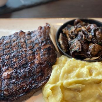J Gilbert's - Bone-in ribeye, Yukon mashed potatoes and wild mushrooms with truffle butter - Bars Near Me - Omaha, Nebraska