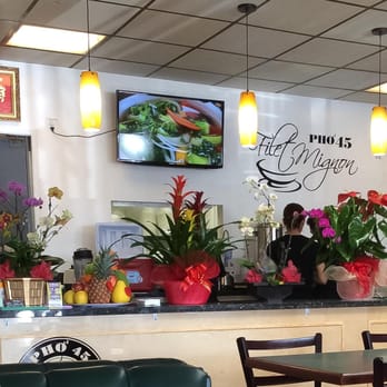 Pho 45 - This is the lovely counter inside with lots of grand opening flowers. - Vietnamese Near Me - La Mirada, California