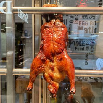 Nations Experience - a whole chicken hanging from a rack - International Grocery Near Me - Toronto, Ontario