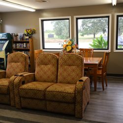 Houston West RV Park - Cozy TV and GamGuest lounge with comfortable seating and a book exchange