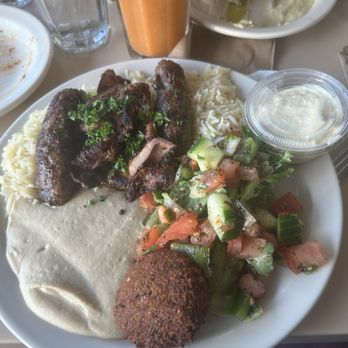 Aladdin's Eatery - Independence - Flavor Savor Special chicken mishwi and beef kafta basmati rice; mixed greens, Lebanese salata, hummus, and falafel - Middle Eastern Near Me - Independence, Ohio