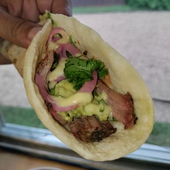 Ember Smoke - The Bark Taco on flour: smoked brisket, spicy guac, pickled onions, cilantro. Yum! - Tacos Near Me