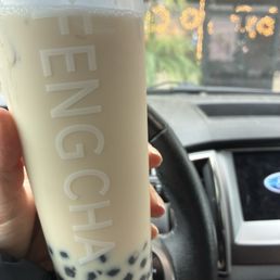 Early grey milk tea with boba, quarter sweet.