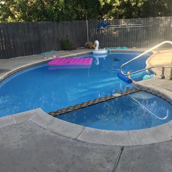 Capstone Pool & Spa Remodeling - The hideous before -- see those tiles falling off, ugly coping, pool is literally painted blue. - Pool & Hot Tub Service Near Me Capstone Pool & Spa Remodeling - The hideous before -- see those tiles falling off, ugly coping, pool is literally painted blue. - Pool & Hot Tub Service Near Me
