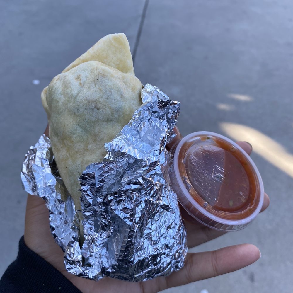 Brother's Burritos - a hand holding a burrito - Mexican Near Me - Hermosa Beach, California Brother's Burritos - a hand holding a burrito - Mexican Near Me - Hermosa Beach, California