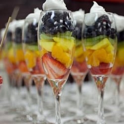 Family Affair Catering and Event Planning Company - Non traditional fruit display. Fruit and whipped cream in champagne glasses.