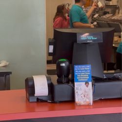 Tropical Smoothie Cafe - Owners Daughter Picking her nose with her hair out over the smoothie station