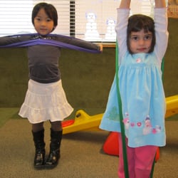 Ladybug Child Care Centers Inc - Exercising with stretchy bands in large muscle!
