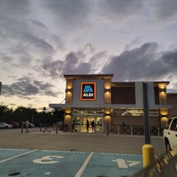 a car parked in front of a aldi store a car parked in front of a aldi store