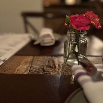 The Drunken Horse - a vase of flowers on a table - Wine Bars Near Me - St. Augustine, Florida