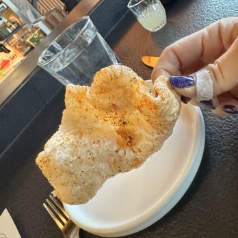 Ember Kitchen - Complimentary fried pork rind and cocktail - Latin American Near Me - Austin, Texas