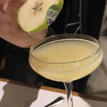 Bottega Louie - Pear Martini with produce sticker still attached to the pear garnish - Italian Near Me - Los Angeles, California Bottega Louie - Pear Martini with produce sticker still attached to the pear garnish - Italian Near Me - Los Angeles, California