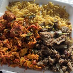 Combo Over Rice Platter with salad and red and white sauce on the side. Combo Over Rice Platter with salad and red and white sauce on the side.