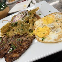 Green chilaquiles,steak asado with well cooked eggs. Green chilaquiles,steak asado with well cooked eggs.