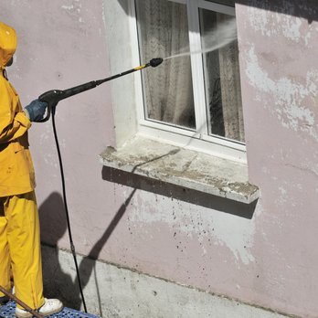 Dubon Fencing - a man in a yellow raincoat using a pressurer - Fences & Gates Near Me - Petersburg, Virginia Dubon Fencing - a man in a yellow raincoat using a pressurer - Fences & Gates Near Me - Petersburg, Virginia