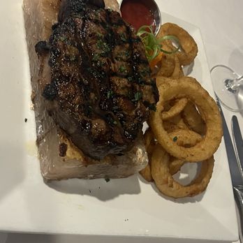 Elizabeth's Chop House - 18oz Ribeye and onion rings. - Steakhouses Near Me - Marquette, Michigan