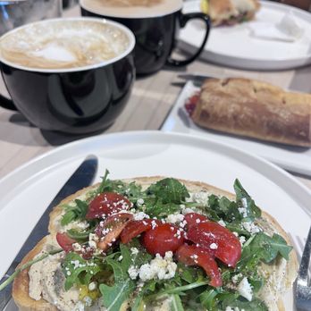 Collect Coffee Bar - Hummus toast, bagel sandwich, crème brûlée latte and a chai tea latte. - Coffee & Tea Near Me - Fresno, California Collect Coffee Bar - Hummus toast, bagel sandwich, crème brûlée latte and a chai tea latte. - Coffee & Tea Near Me - Fresno, California