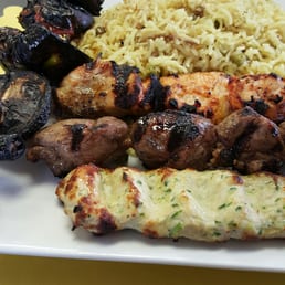 Mixed Grill... With charred vegetable kabob (it was replaced). Tea in background, with side of sugar. Mixed Grill... With charred vegetable kabob (it was replaced). Tea in background, with side of sugar.