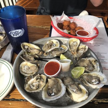 Half Shell Raw Bar - Happy Hour oysters which were amazingly fresh and conch fritters! So delicious and right by the water & great location to walk around - Seafood Near Me - Key West, Florida