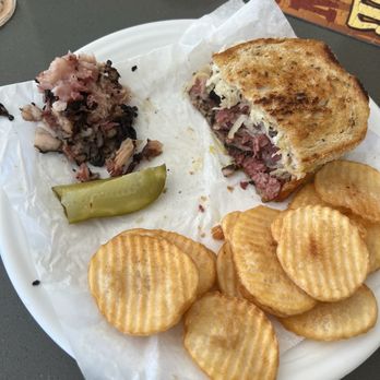 Sherman's Deli & Bakery - Grilled Reuben with the fat from one half on the left - Bakeries Near Me - Palm Desert, California Sherman's Deli & Bakery - Grilled Reuben with the fat from one half on the left - Bakeries Near Me - Palm Desert, California