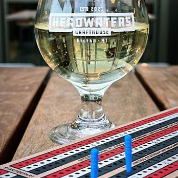 Headwaters Crafthouse - a glass of wine and a cribbag on a wooden table - Beer Bar Near Me - Helena, Montana Headwaters Crafthouse - a glass of wine and a cribbag on a wooden table - Beer Bar Near Me - Helena, Montana