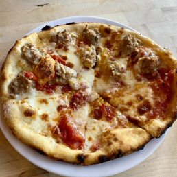 Fennel sausage, tomato, mozzarella, and basil pizza.
