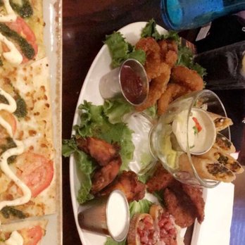 Hard Rock Cafe - Margherita flatbread pizza (missing half in the picture) and the Jumbo Appetizer combo filled two adults right up. - Burgers Near Me - Key West, Florida Hard Rock Cafe - Margherita flatbread pizza (missing half in the picture) and the Jumbo Appetizer combo filled two adults right up. - Burgers Near Me - Key West, Florida