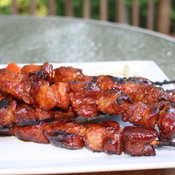 Chow Down LA - skewered meat on a white plate - Food Trucks Near Me Chow Down LA - skewered meat on a white plate - Food Trucks Near Me
