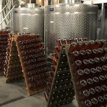 Milagro Farm Winery - Barrel Room with racked bottles of sparkling Brut Rosé. - Wineries Near Me - Ramona, California