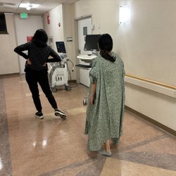 Sister Doulas - Allison leads my partner through some lunge-like walking exercises in the Alta Bates corridor.