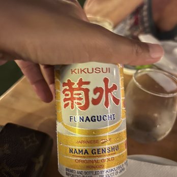 Sen - a person holding a can of food on a table - Sushi Bars Near Me - Sag Harbor, New York
