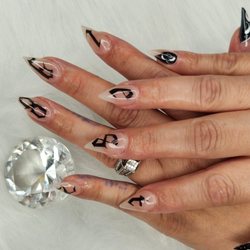 Magic Nails - Hands down Alex is one of the best nail techs in town. Everyone is super nice, I'd you want precision and artsy nails go to Alex .