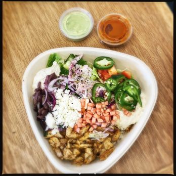 NAYA - Naya bowl with chicken shawarma and a ton of fixin's, red & green hot sauces on the side - Mediterranean Near Me - Montvale, New Jersey