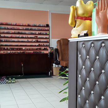 Nail Palace - Pic of a hand  and the finger nail polish on the wall they do feet, finger nails and eye brow it's  5 or six people helping customers - Nail Salons Near Me - Jacksonville, Florida