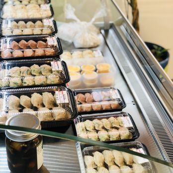 Mannane - several trays of food on a conveyor belt - Korean Near Me - Fort Lee, New Jersey
