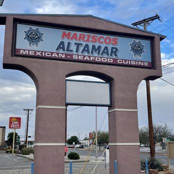 Mariscos Altamar - A large sign for Mariscos Altamar, a Mexican seafood restaurant, is displayed in a parking lot with a blue sky and clouds overhead. - Mexican Near Me - Albuquerque, New Mexico