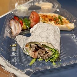 Fabi’s Grill - Beef Steak Wrap. Sides: grilled veggies and Hummus. Yogurt and spicy mayo comes with. So good