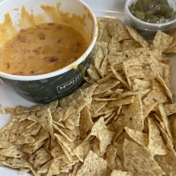 McAlister's Deli - Nacho basket of mostly crushed chips.  Disappointing. - Delis Near Me - Albuquerque, New Mexico