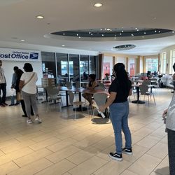USPS - A line of customers waiting for the post office to open DURING THEIR BUSINESS HOURS, because it's closed.
