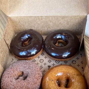 Holey Grail Donuts - From lower left, Theobroma, island chocolate and og glazed. - Donuts Near Me - Honolulu, Hawaii Holey Grail Donuts - From lower left, Theobroma, island chocolate and og glazed. - Donuts Near Me - Honolulu, Hawaii