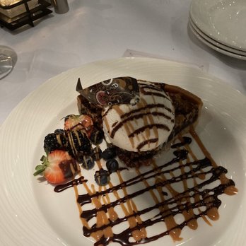Nineteen 86 Steakhouse - Pecan Tart topped with vanilla ice cream. - Steakhouses Near Me - Glendale, Arizona Nineteen 86 Steakhouse - Pecan Tart topped with vanilla ice cream. - Steakhouses Near Me - Glendale, Arizona