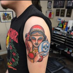 Golden Toad Tattoo - Color neo-traditional upper-arm tattoo featuring a stylized woman's portrait, decorative headpiece, rose and blue skull by Ian Haines
