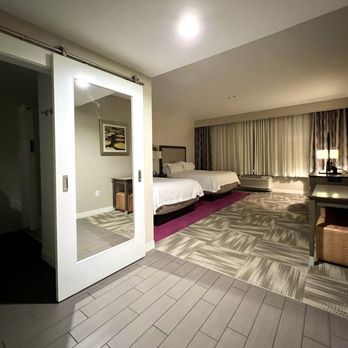Hampton Inn Huntsville/Village of Providence - Room 422. Bathroom to the left, bedroom straight ahead, and tables to the right. - Hotels Near Me - Huntsville, Alabama Hampton Inn Huntsville/Village of Providence - Room 422. Bathroom to the left, bedroom straight ahead, and tables to the right. - Hotels Near Me - Huntsville, Alabama