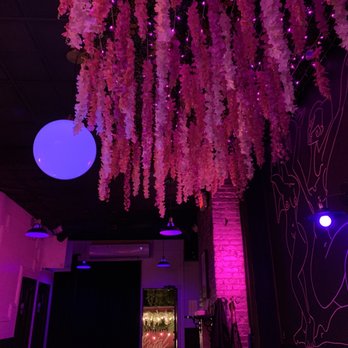 Pink Metal - a woman sitting at a bar - Cocktail Bars Near Me - Brooklyn, New York